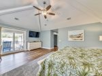 Master Bedroom with Mounted TV and Private Deck Overlooking Pool at 29 Pelican
